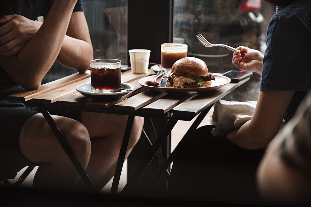 person holding stainless steel fork and bread knife