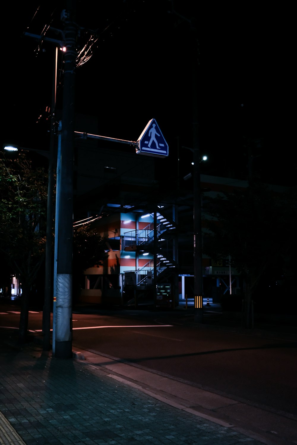 people walking on sidewalk during night time