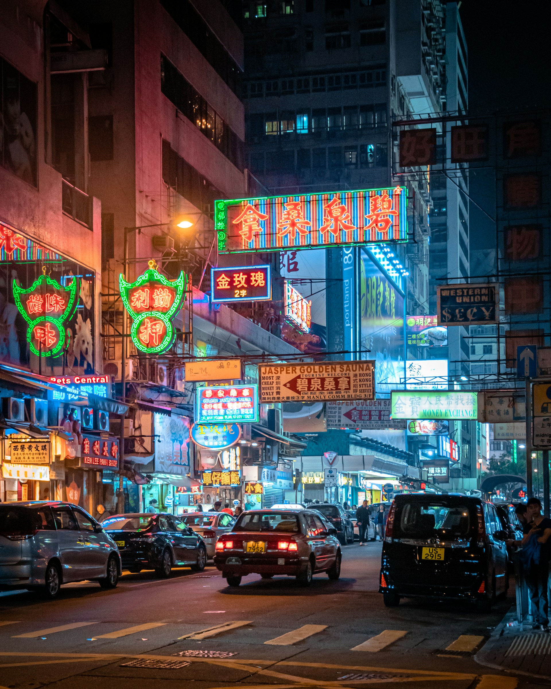 A bustling street scene in Shanghai at night with colorful neon lights and traditional lanterns.