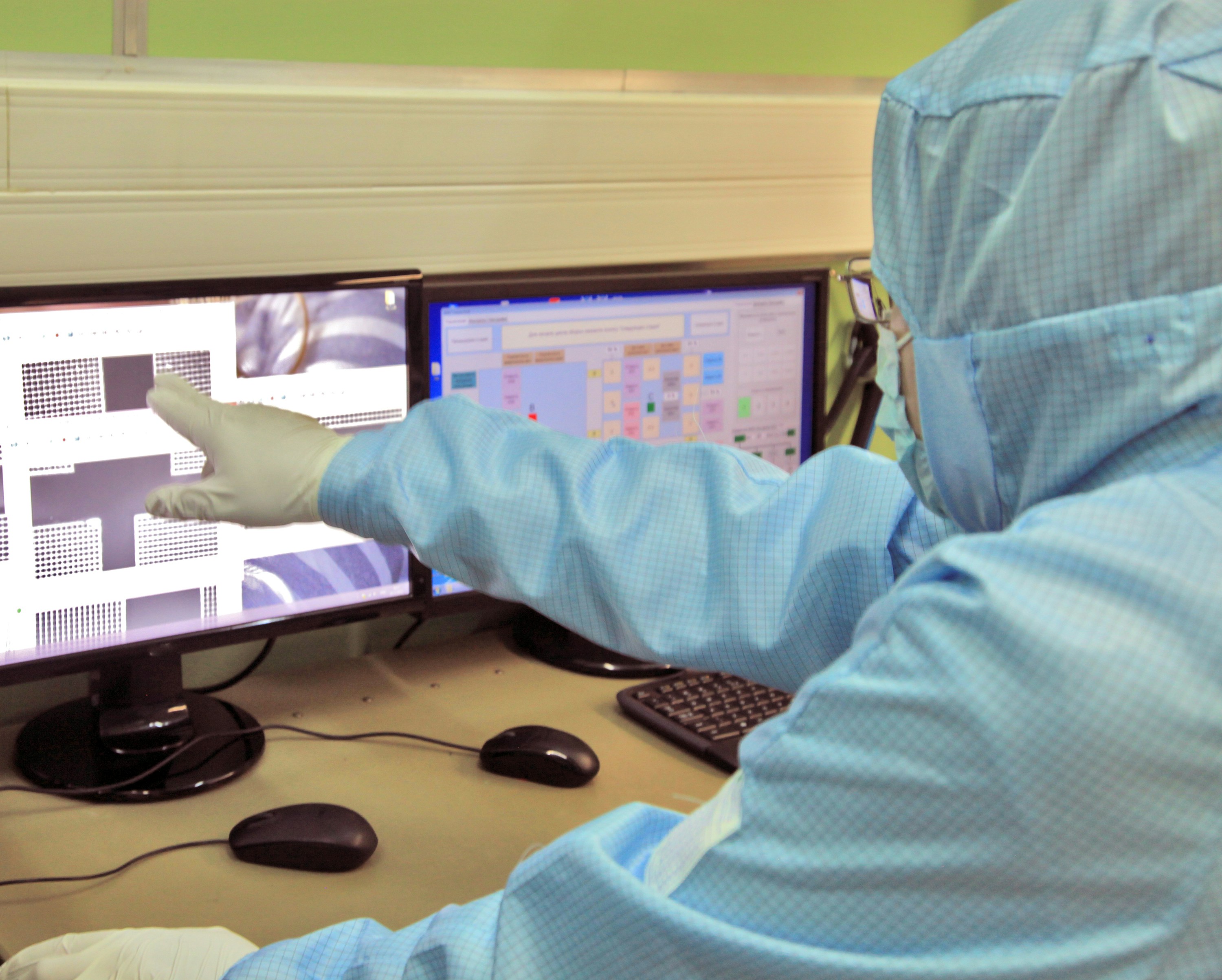 scientist analyzing genetic data on monitor in clean laboratory