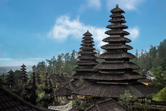 brown and black temple under blue sky during daytime in Mother Temple of Besakih Indonesia