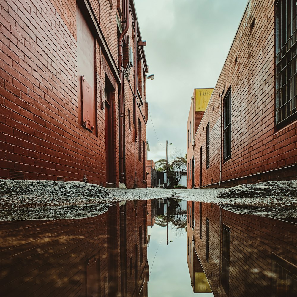 brown brick building beside body of water during daytime