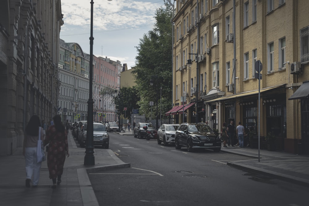 cars parked on side of the road near buildings during daytime