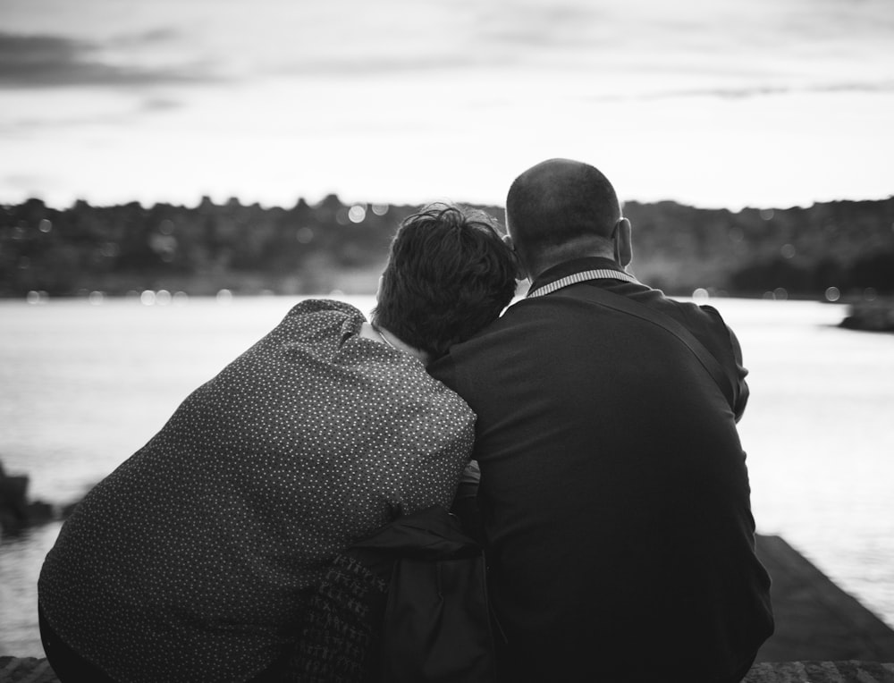 man and woman kissing on beach