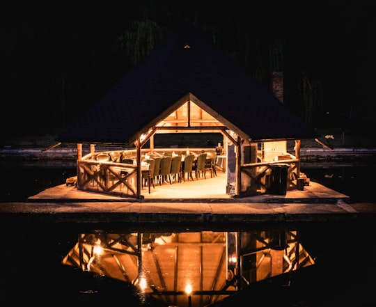 brown wooden house during night time in Nehoiu Romania