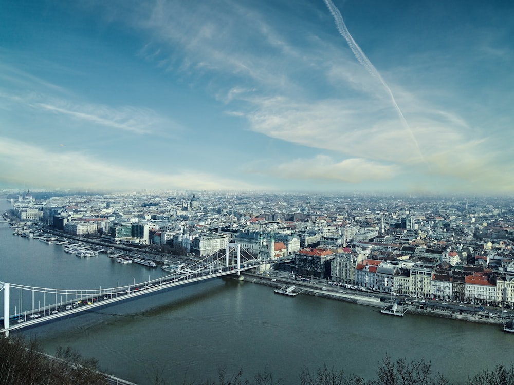 city skyline under blue sky and white clouds during daytime