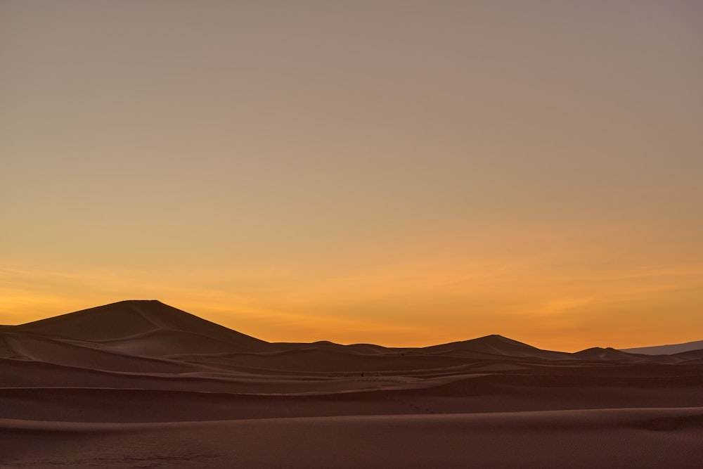 Brauner Sand unter orangefarbenem Himmel