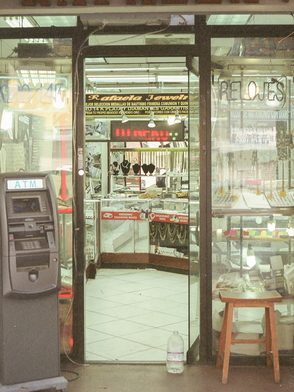 black and gray atm machine beside clear glass wall