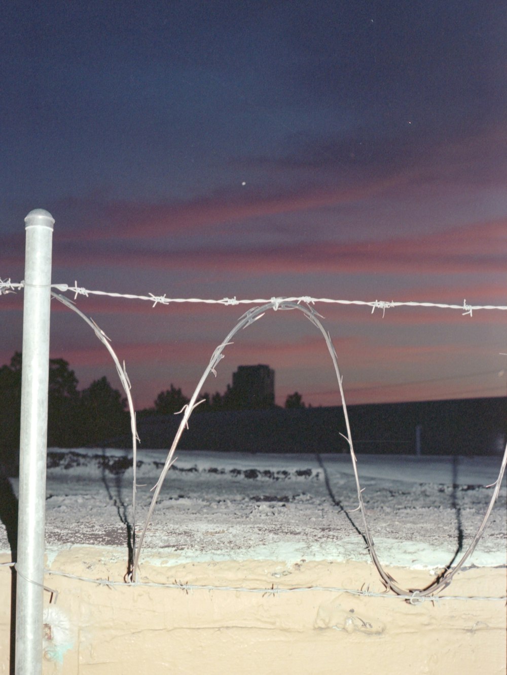 white metal post on white sand during night time