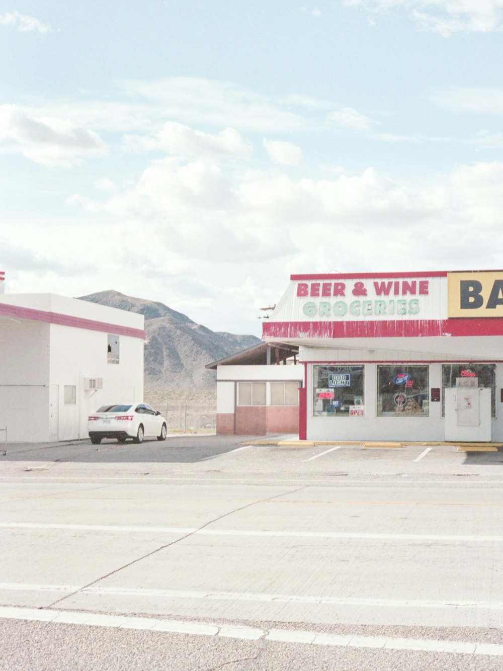 a car parked in front of a bar and wine store