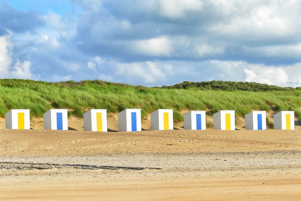 white wooden post on brown field under white clouds and blue sky during daytime