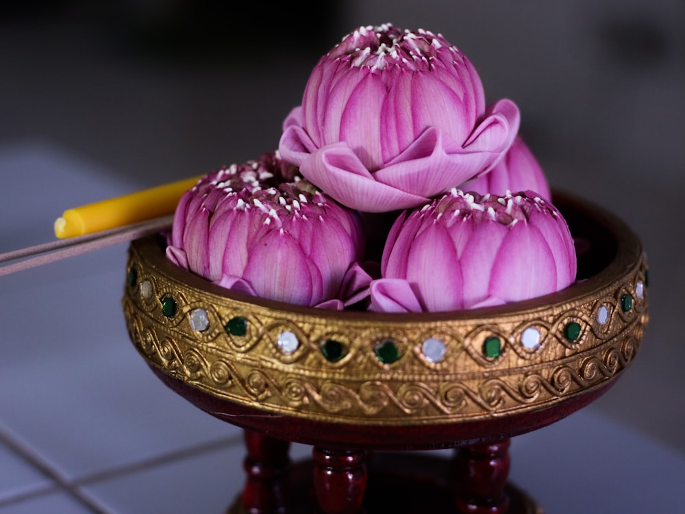 pink and yellow flower on brown wooden table