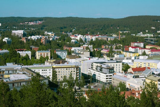 white concrete building near green trees during daytime in Jyväskylä Finland