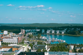 aerial view of city buildings near body of water during daytime