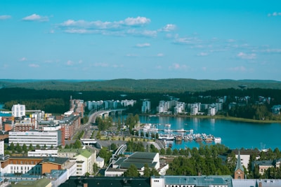 aerial view of city buildings near body of water during daytime