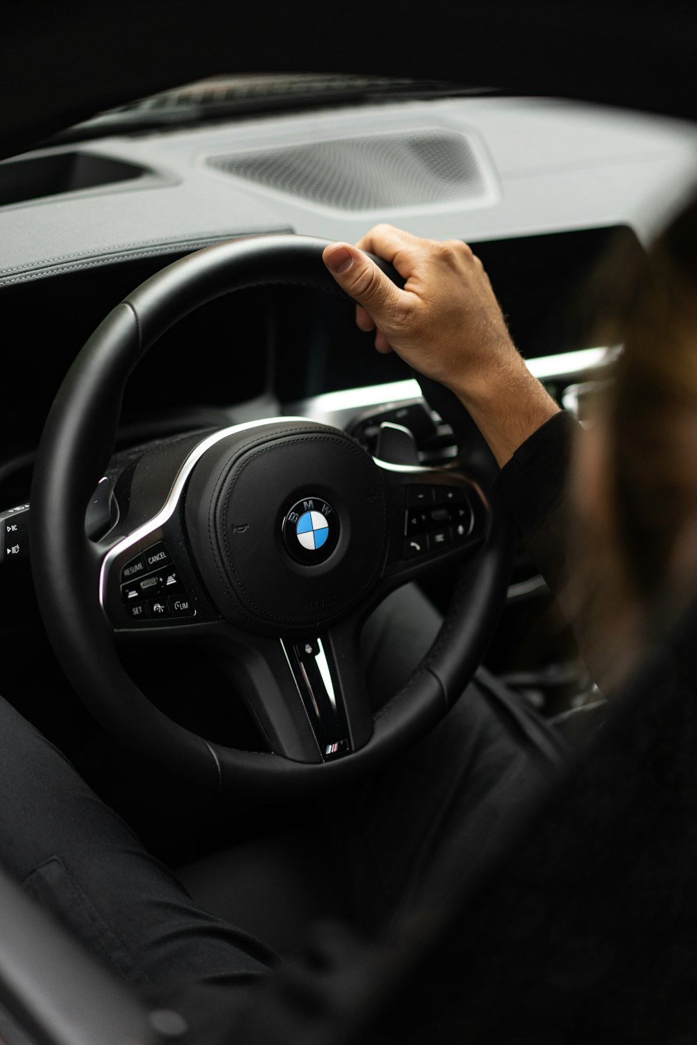 person holding black mercedes benz steering wheel