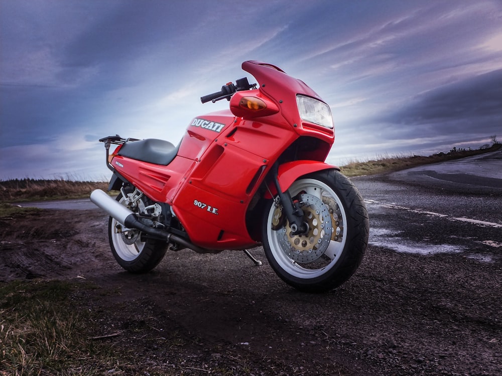 red and black motorcycle on black sand during daytime