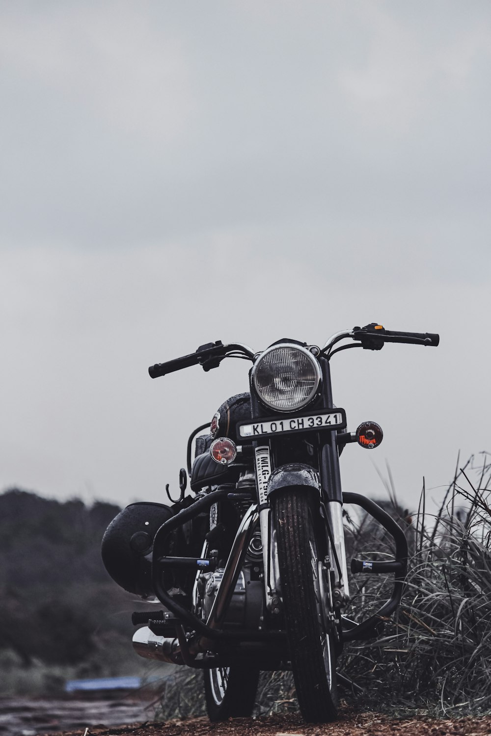 black motorcycle on brown grass field during daytime