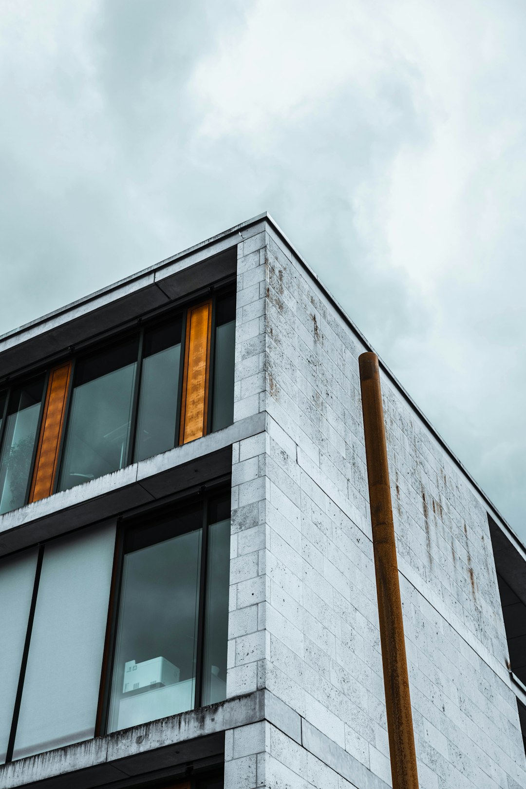 brown and gray concrete building under white clouds during daytime