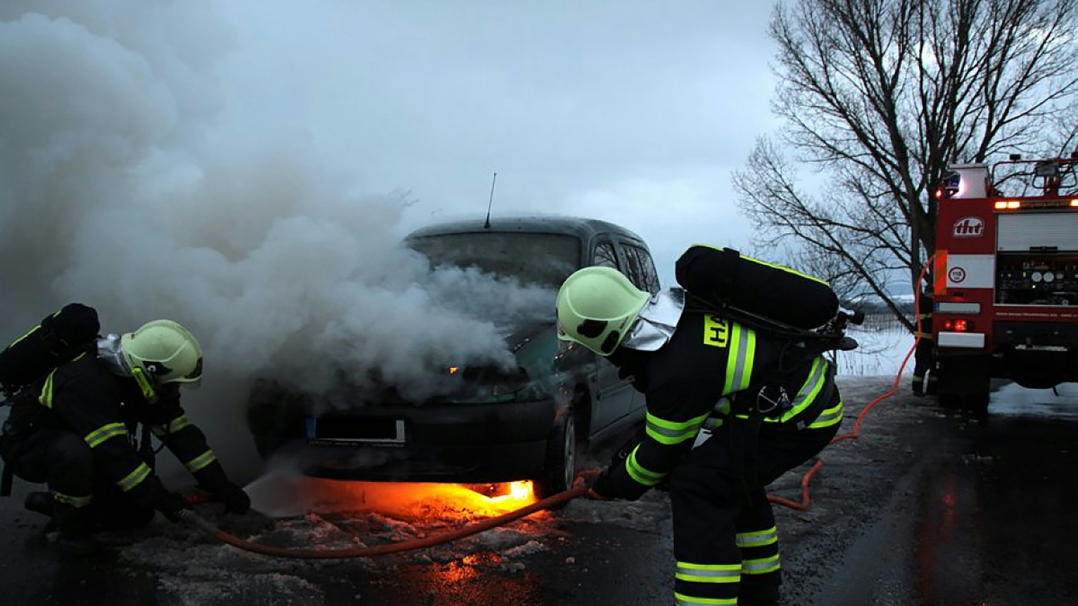 man in black helmet and black helmet standing on fire