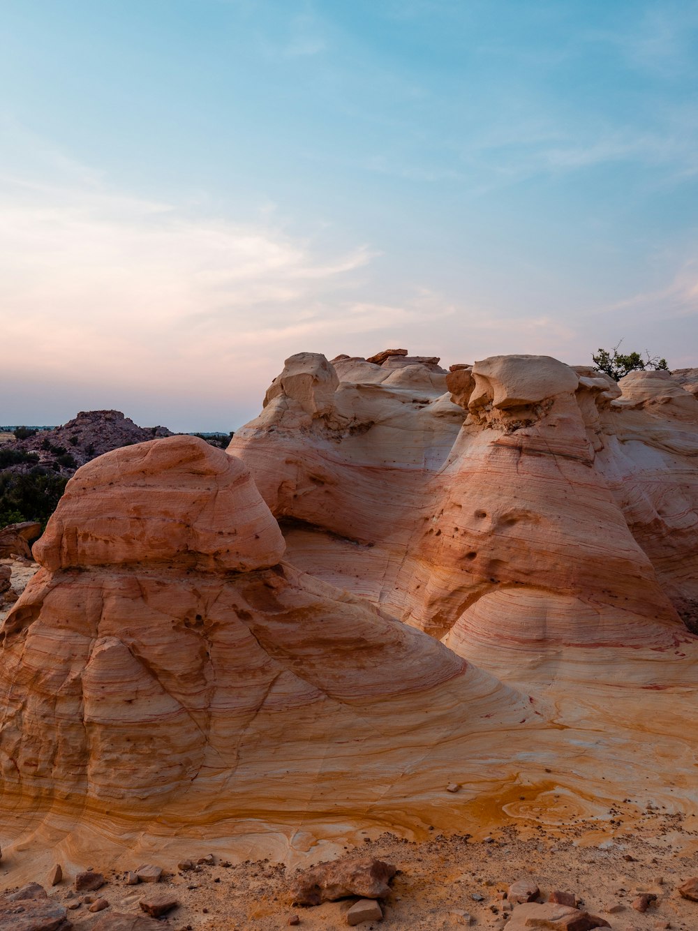 brown rock formation under white clouds during daytime