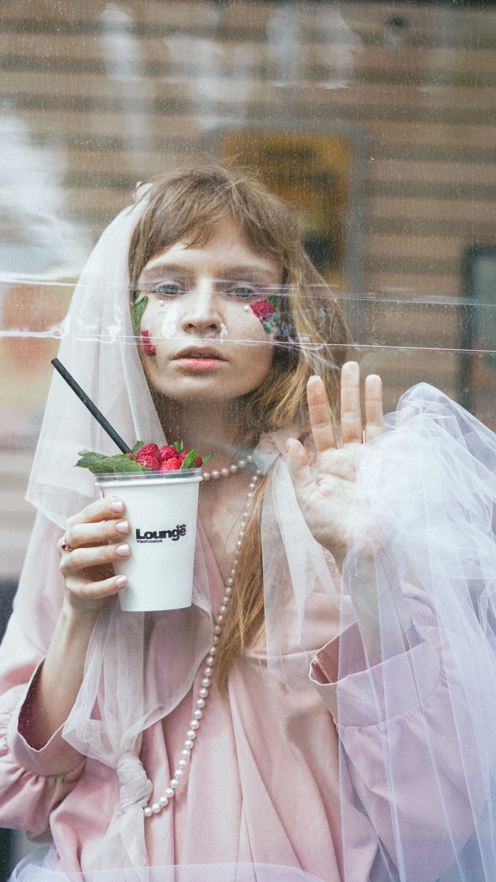 girl in white dress holding white cup