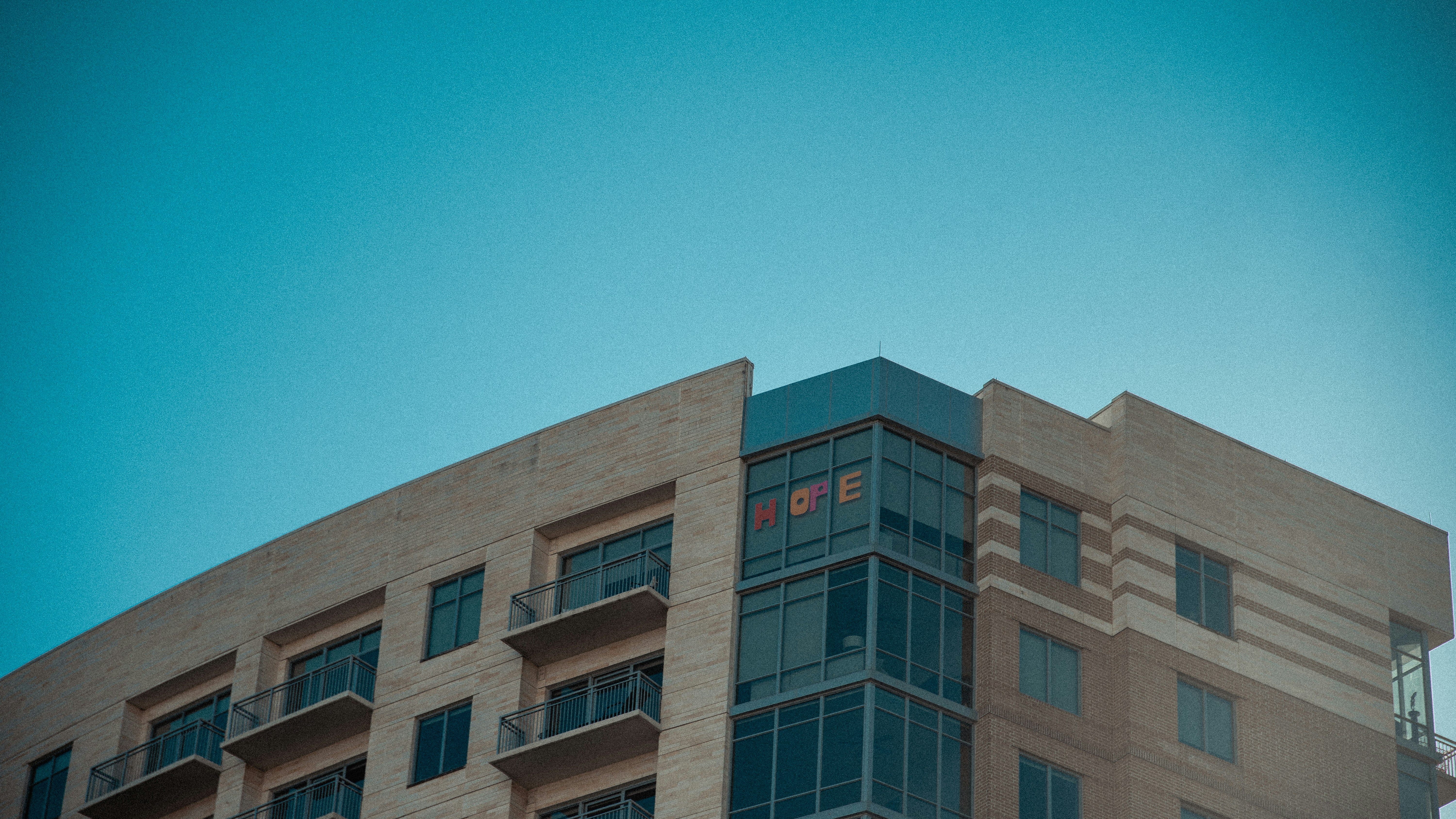 REIT commercial real estate net lease - brown concrete building under blue sky during daytime