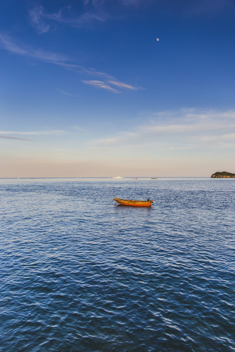 yellow kayak on blue sea under blue sky during daytime