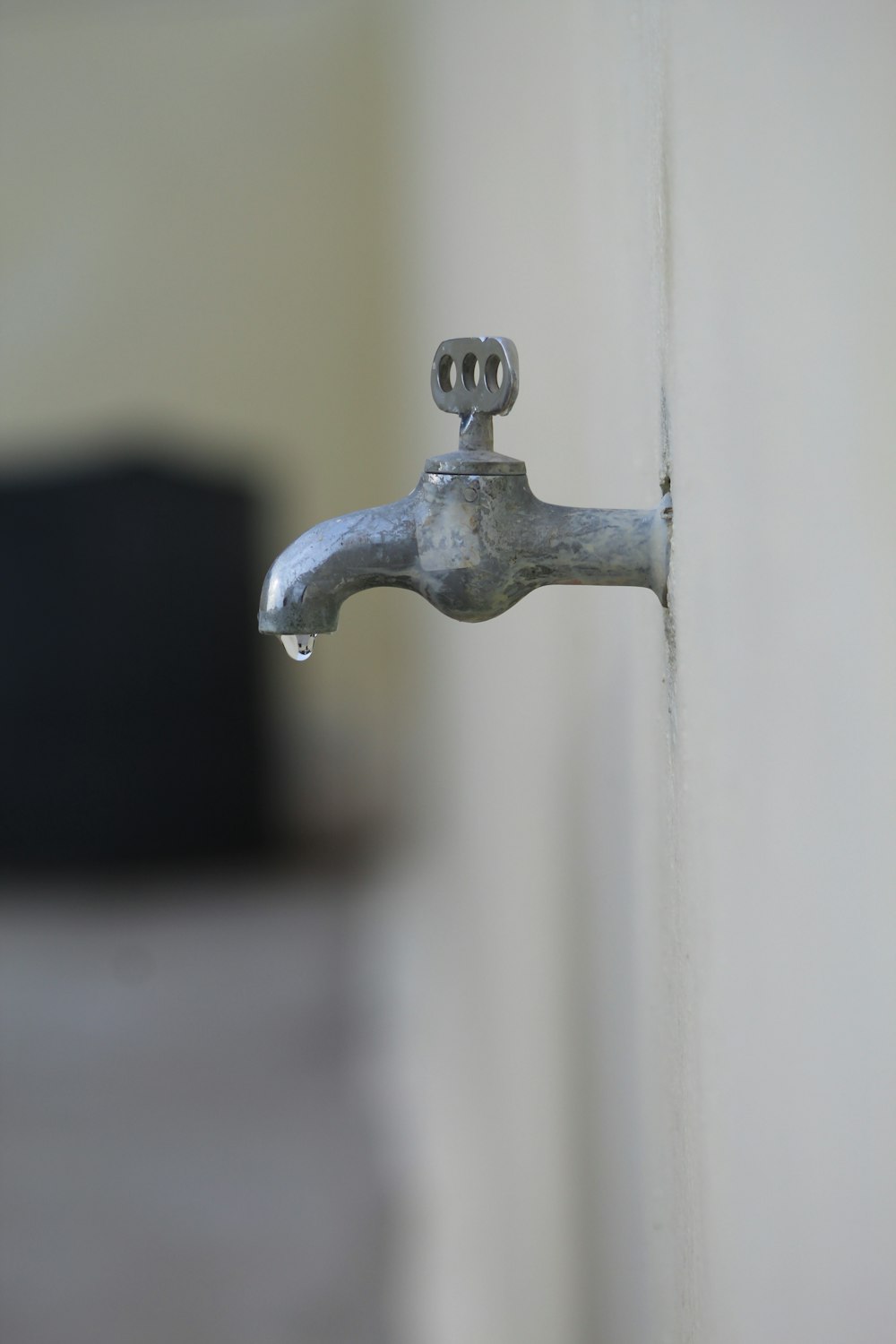 grey metal faucet in close up photography