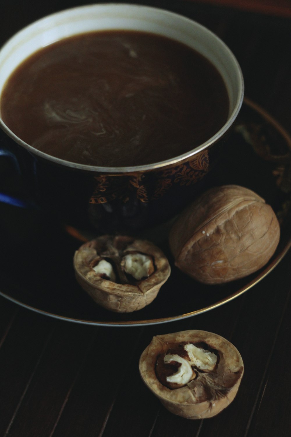 brown and white ceramic mug beside brown cookies