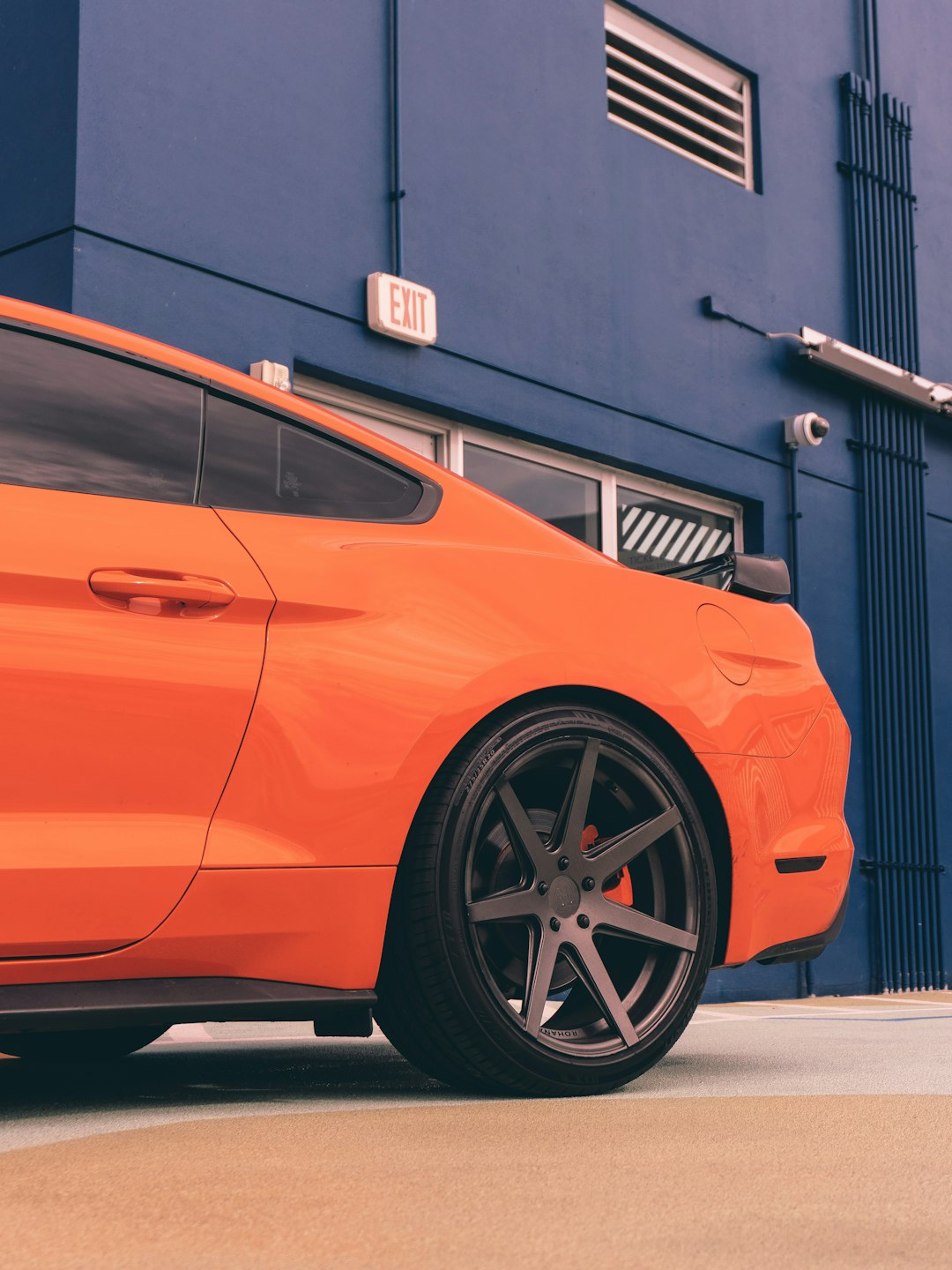 orange car parked near building