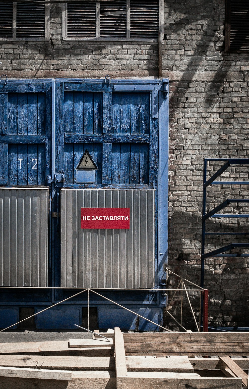 blue wooden door on brick wall