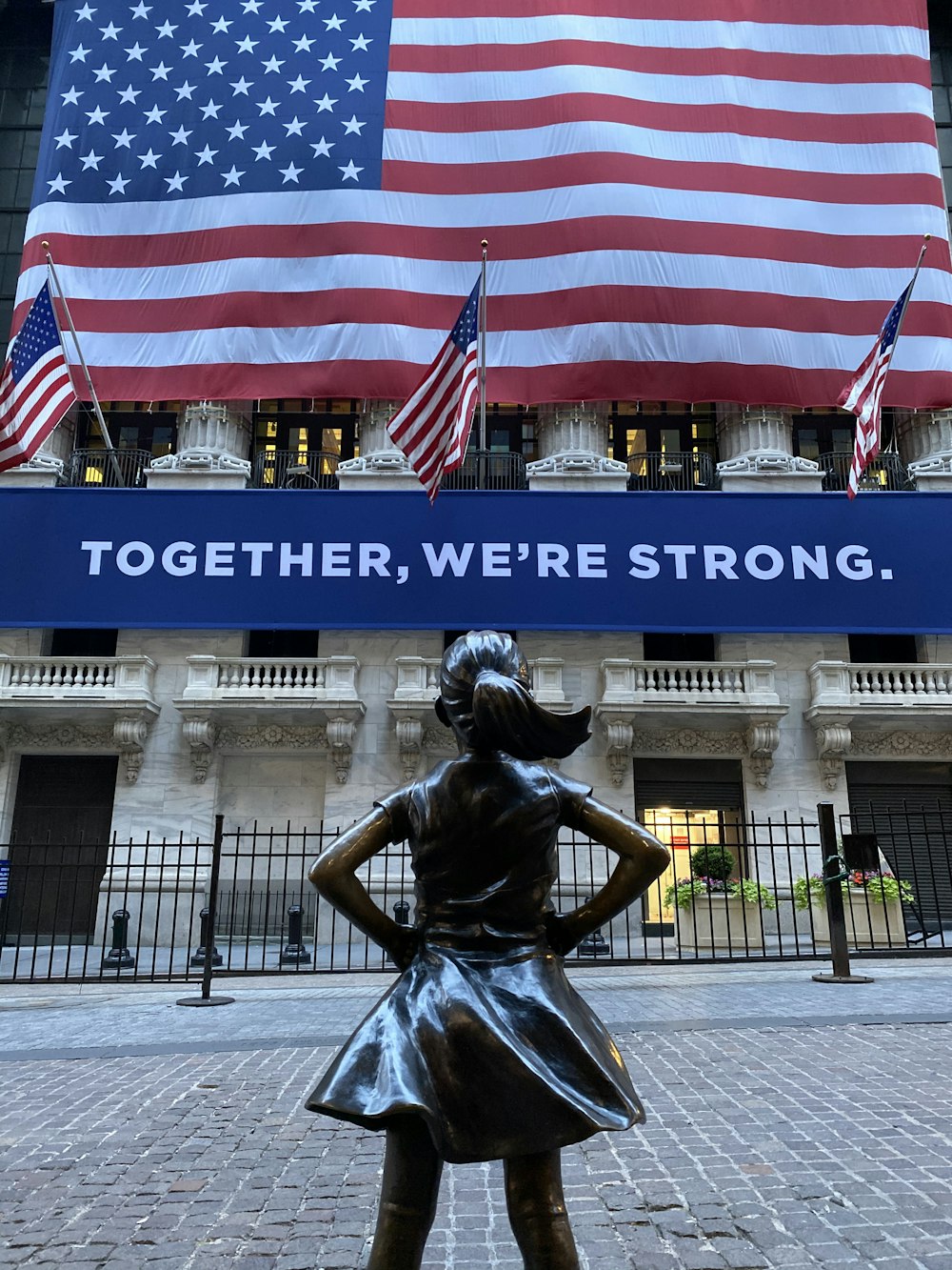 woman in black dress statue near american flag during daytime