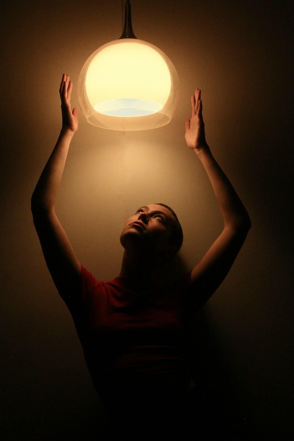 man in black tank top holding round light