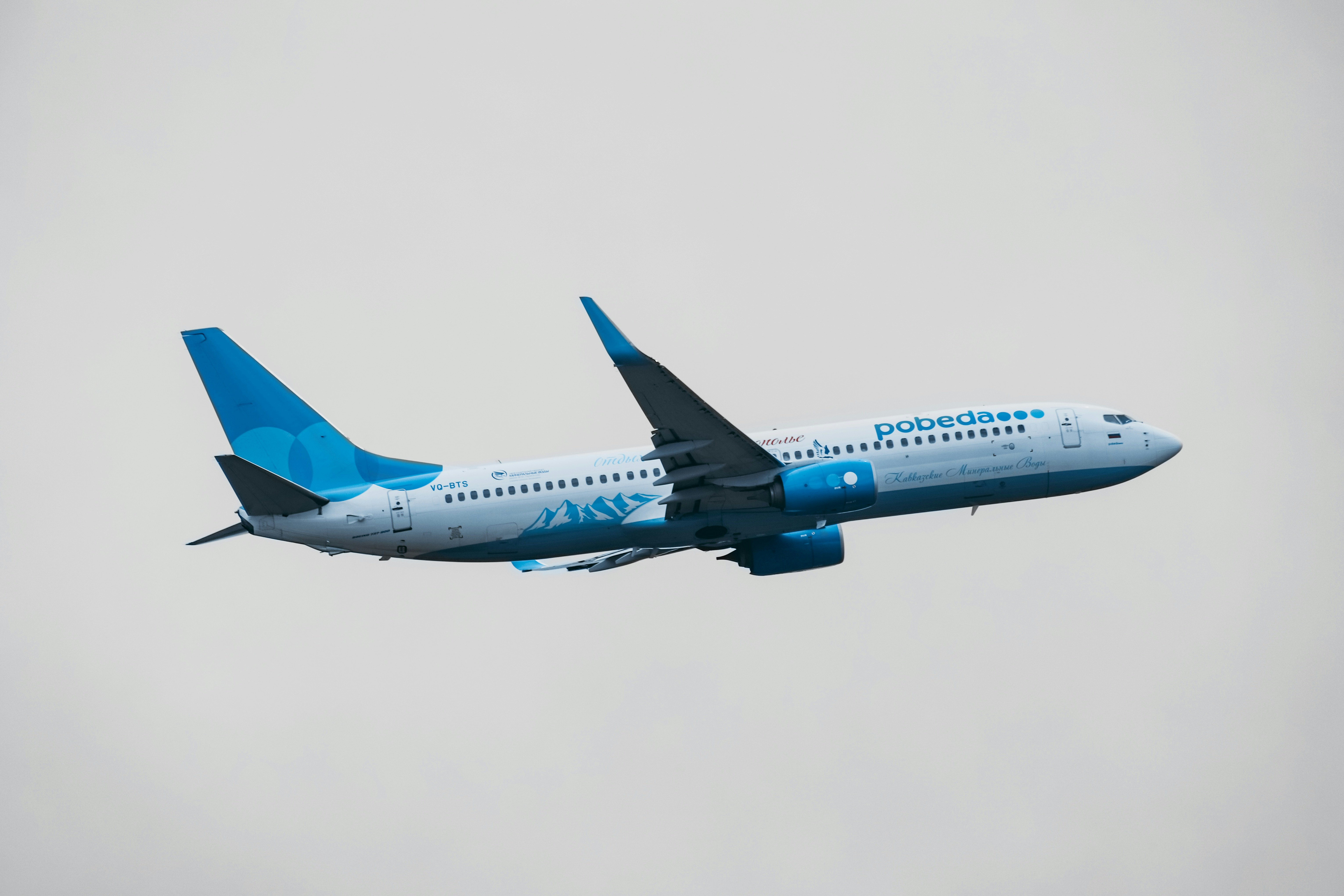 blue and white airplane in mid air, 