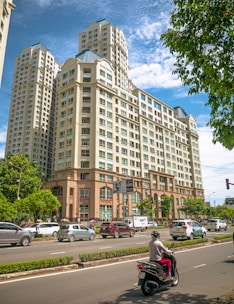 cars parked in front of brown building during daytime