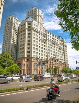 cars parked in front of brown building during daytime