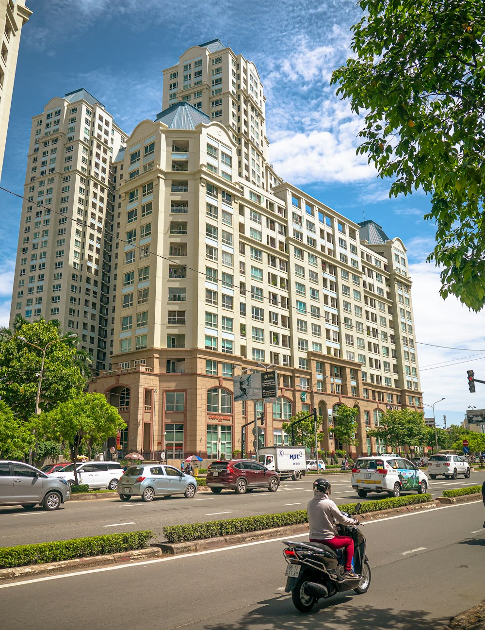 cars parked in front of brown building during daytime