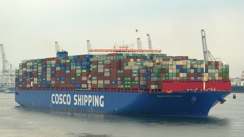 blue cargo ship on sea during daytime