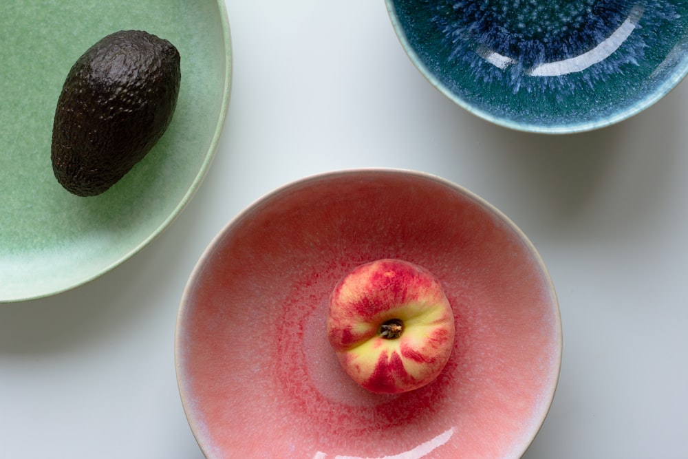 red apple fruit on white plate