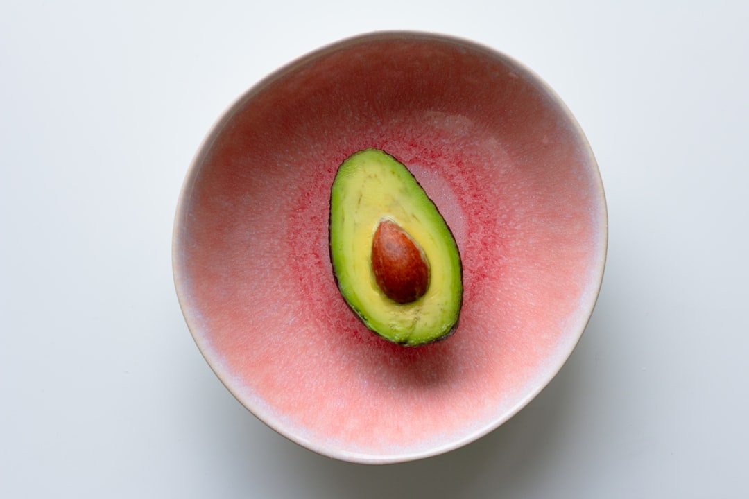 Avocado in a pink rustic bowl 