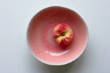 red apple fruit on white table