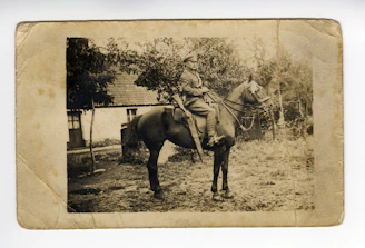 A vintage photograph of a soldier in uniform from the early 1900s.