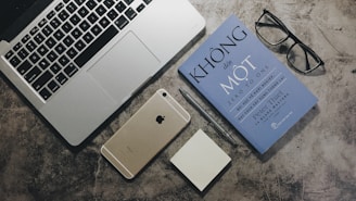 silver ipad beside silver macbook