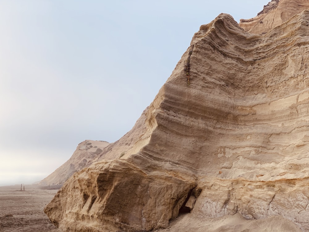 brown rock formation under white sky during daytime