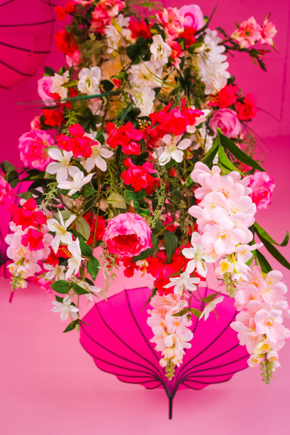 pink and white flowers on red table
