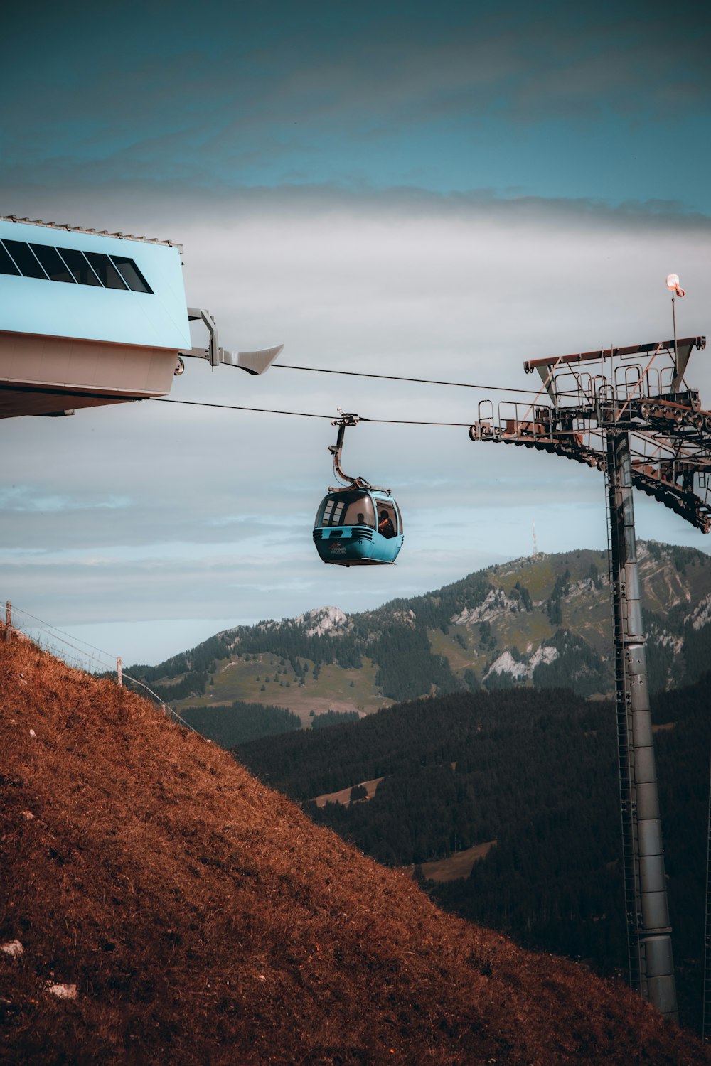white and black cable car over the mountains during daytime