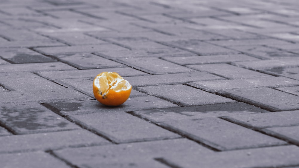 orange fruit on brown brick floor