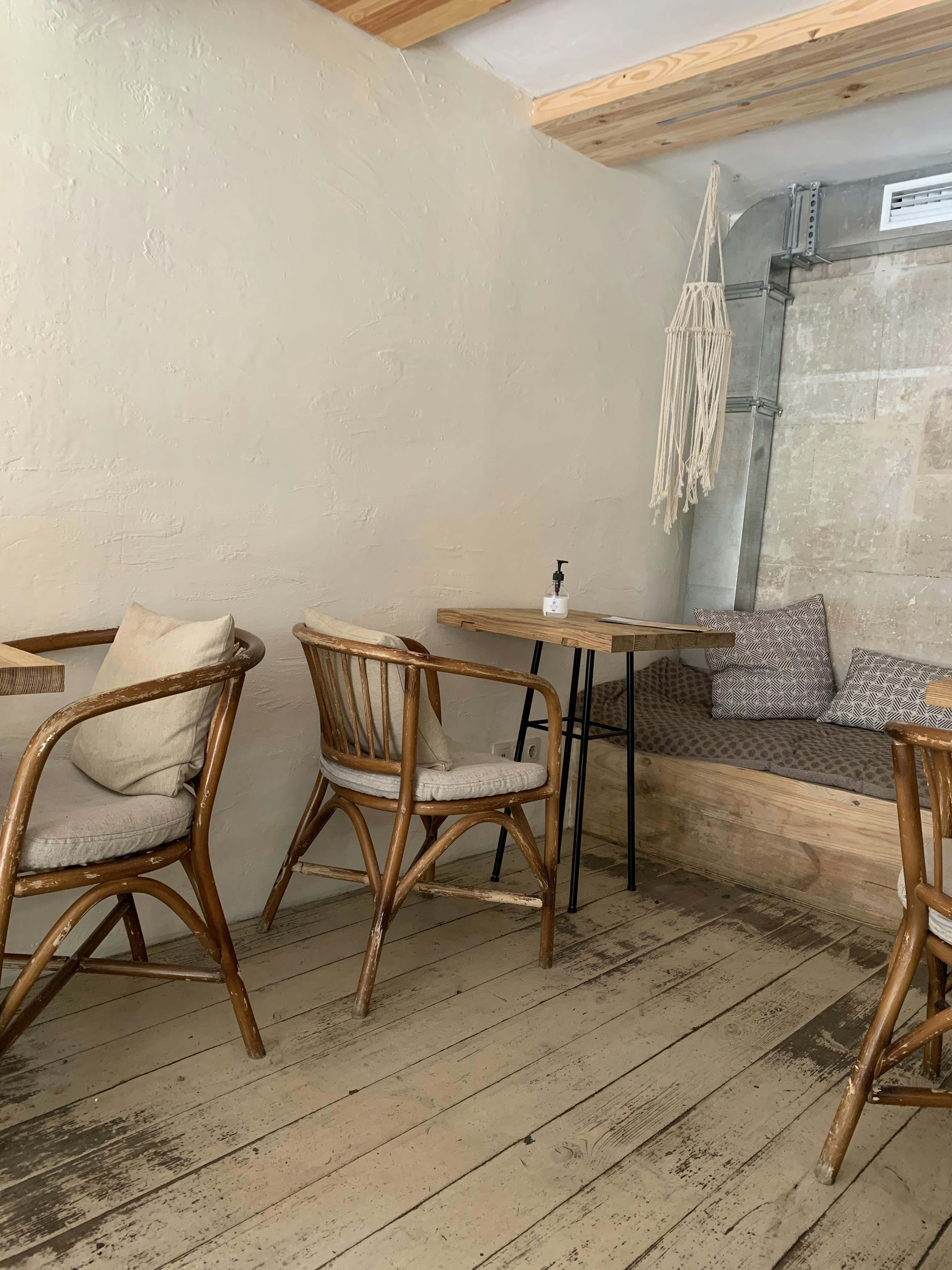 Custom designed café furniture with mixed material seating, timber tables, and built-in banquette seating