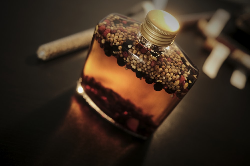 a glass bottle with a cork top on a table